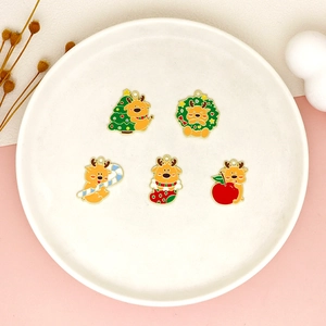 Detailed view of colorful enamel Christmas reindeer charms on a white plate