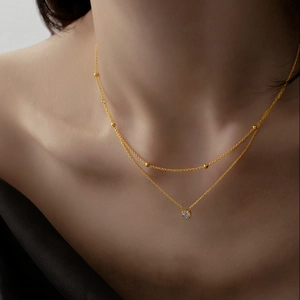 Elegant double-layered gold titanium necklace with a sparkling solitaire zircon pendant