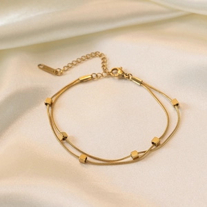 Elegant gold double-layered snake chain necklace with small square cube charms on silk