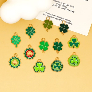 Vue macro de divers pendentifs trèfles en émail vert pour la création de bijoux DIY créatifs