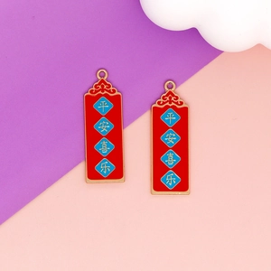 Detailed macro shot of Chinese style red enamel charms with auspicious Peace and Joy text