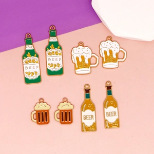 Detailed view of colorful enamel beer bottle and mug charms for DIY jewelry making kits.