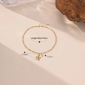 Detail shot of starfish and pearl pendant on a gold titanium chain with measurements