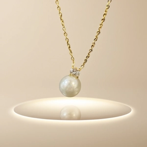 Elegant gold titanium necklace with a single Baroque pearl and sparkling diamond accent