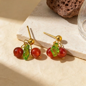Elegant cherry pendant necklace with red agate beads and green leaf charms on stone