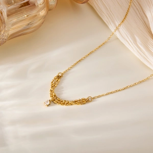 Elegante collana in titanio dorato con ciondolo in zircone su catena a maglia fine