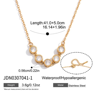 Gold stainless steel necklace with five circular clear crystals and extension chain