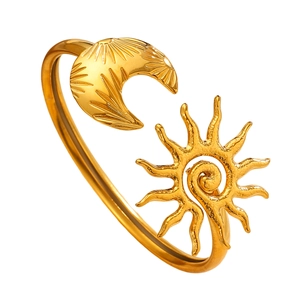 Detailed view of golden stainless steel bangle with sun and moon celestial motifs
