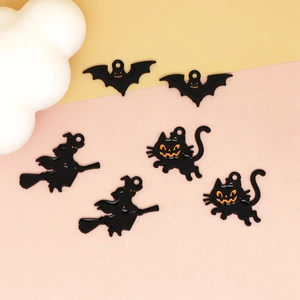Detail of mixed Halloween alloy enamel charms featuring bats, cats, and witches