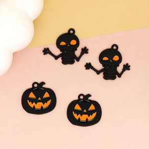 Close-up of Halloween pumpkin and skeleton alloy charms for creative DIY jewelry making.