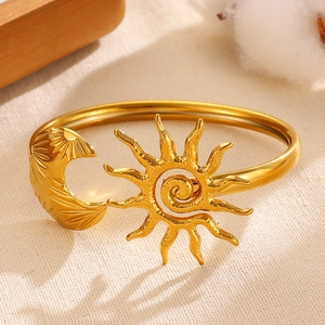 Detail view of high-quality gold plated sun and moon stainless steel asymmetrical bangle