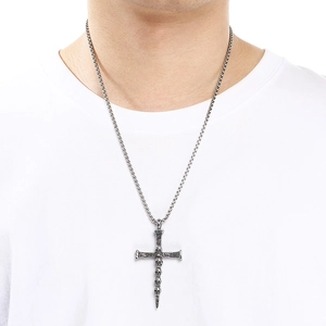 Primer plano de un collar con colgante de silbato de cruz de calavera gótica en acero