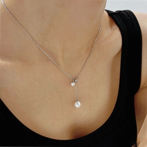 Elegant silver-toned Y-shaped necklace with dual layered pearls on a female model