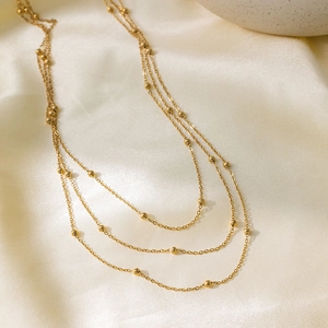 Elegant multi-layer gold bead choker necklace with minimalist triple-strand chain design