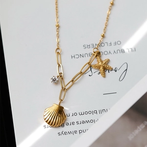 Collana in titanio dorato con stella marina e conchiglia, catena a graffetta da mare