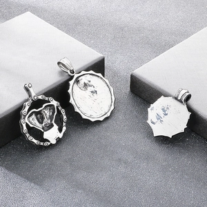 Detailed view of three vintage blackened titanium steel skull pendants for men