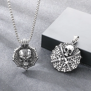 Close-up detail of vintage skull pendants in stainless steel for gothic biker style.