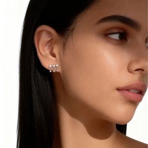 Close-up of s925 silver stud earrings with small square settings and round crystal drops