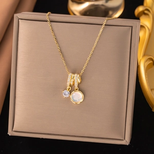 Golden titanium steel necklace with zircon rings and cat eye stone on jewelry pad