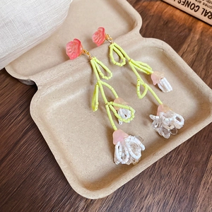 Handmade pink and yellow beaded floral tassel earrings for a stylish vacation look
