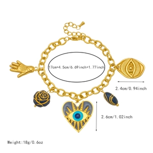 Gold evil eye charm bracelet with hamsa hand and blue rose heart pendants on white background