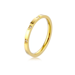 Detail of gold titanium ring with three inset diamonds and a flat minimalist geometric band