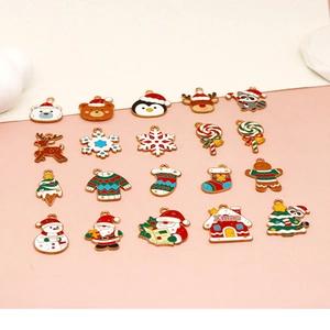 Variety of Christmas enamel charms featuring Santa, snowflakes, and gingerbread men for DIY