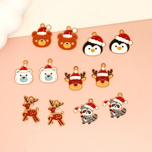 Detail showing assorted Christmas enamel charms including reindeer and raccoons for DIY jewelry