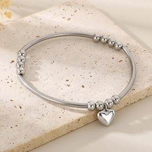 Minimalist stainless steel bead bracelet with a silver heart pendant for women.