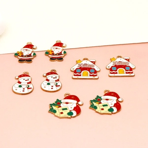 Detailed view of assorted Christmas enamel charms including Santa Claus and snowmen