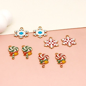 Detail view of colorful enamel Christmas charms including snowflakes and lollipops jewelry.