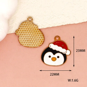 Close-up of enameled penguin charm with Christmas hat showing size and weight
