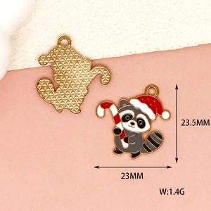 Detail view of raccoon Christmas charm showing dimensions, front design and back texture