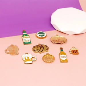 Detail of beer-themed enamel charms including mugs, bottles, and barrels for DIY jewelry