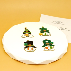 Four St. Patrick's Day lucky gnome charms with green clovers for DIY jewelry making