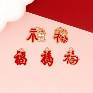 Detailed view of Chinese Dragon Year Fu character charms with red enamel and gold finish.