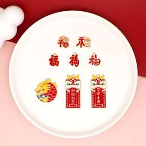 Close-up of Chinese New Year DIY charms with dragon and Fu characters on white plate