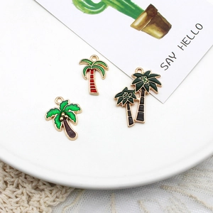 Close-up view of three colorful alloy enamel coconut palm tree pendants for DIY jewelry