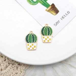 Close-up detail of green enamel cactus plant charms for creative DIY jewelry making projects