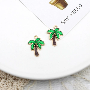 Close-up of small green enamel palm tree alloy charms for DIY jewelry making accessories