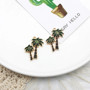 Detailed close-up of palm tree alloy pendants for DIY jewelry making with tropical style.