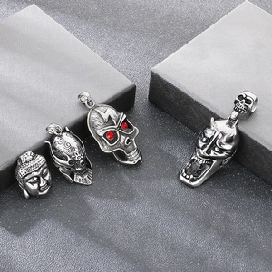 Detailed view of Gothic Viking stainless steel pendants with Buddha and skull designs