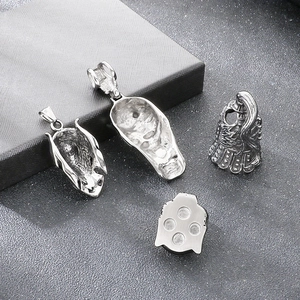 Close-up detail of gothic Viking helmet and skull pendants in stainless steel