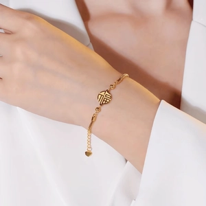 Golden titanium steel bracelet with Fu character pendant and adjustable heart charm on wrist
