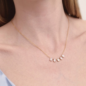Close-up of 18K gold plated stainless steel necklace with five teardrop zircons.