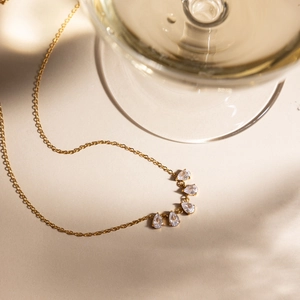 Elegant 18K gold stainless steel necklace with five teardrop zirconia stones detail.