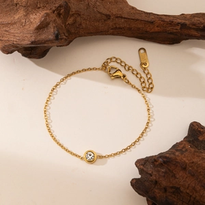 Bracelet minimaliste chic en acier inoxydable doré avec un seul cristal rond brillant