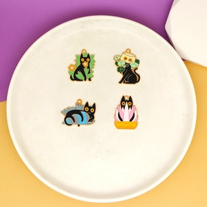Set of whimsical black cat enamel charms with plant elements for DIY jewelry making