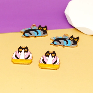 Close-up of Halloween black cat and plant enamel charms for DIY jewelry