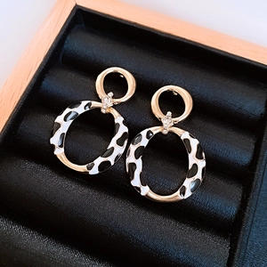Vintage gold drop earrings with black and white cow print enamel and crystal accents